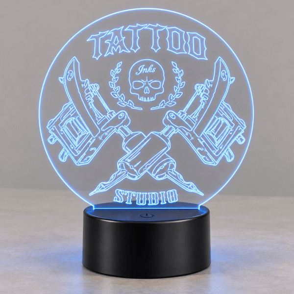 Lámpara LED Tattoo de metacrilato con luz azul y base negra, encendida de día
