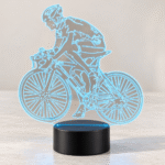 Lámpara LED Bicicleta con ciclista, luz azul y base negra, encendida de día